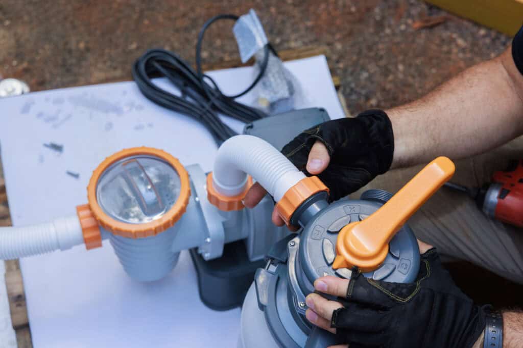 Pool equipment setup with pump and filter for swimming pool installation.