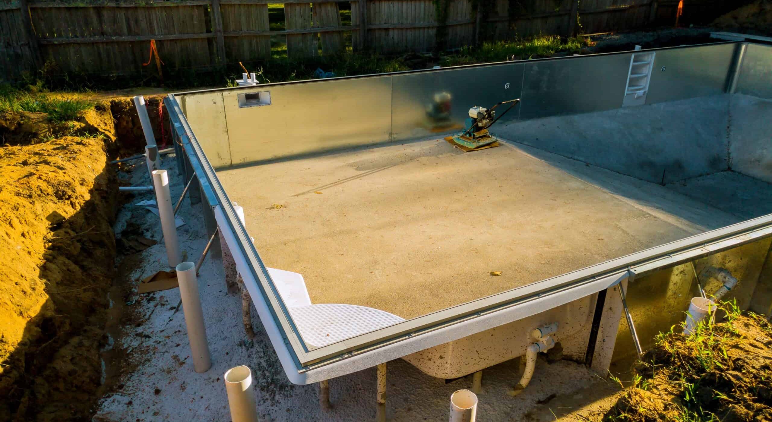 Inground pool with new plastering and glass fencing by Jms Pool Plastering.